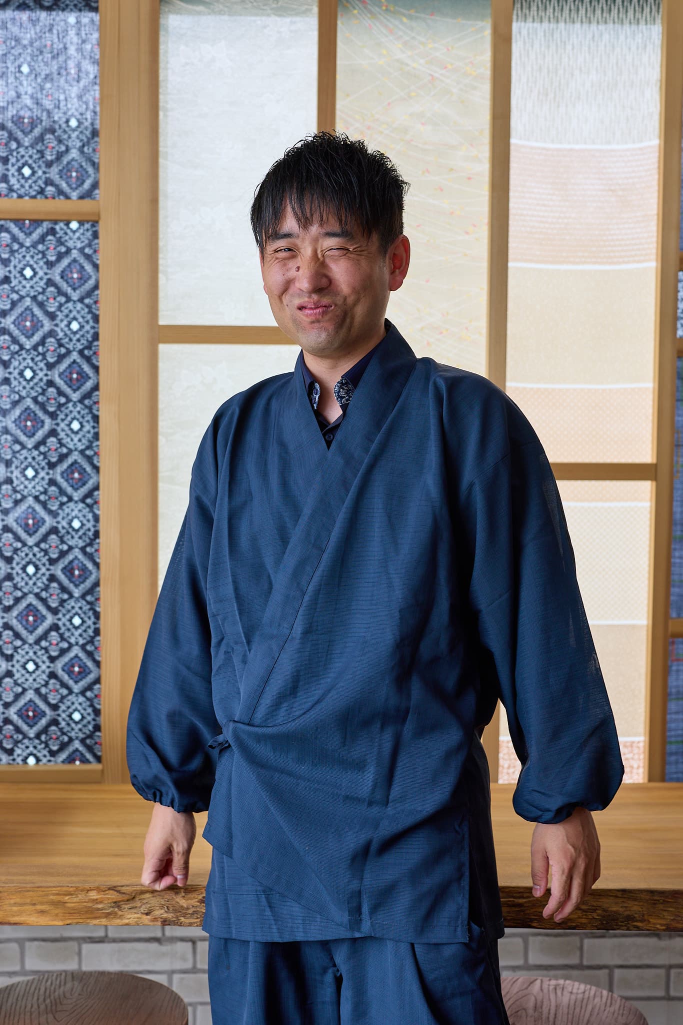 穏やかに微笑む、紺の作務衣姿の書家 森下友喜